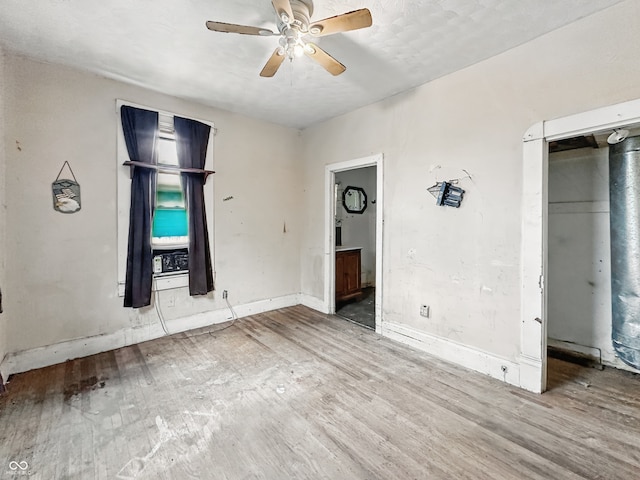 2006 N Olney St, Indianapolis, IN 46218 - unfurnished bedroom with wood finished floors, baseboards, and a ceiling fan