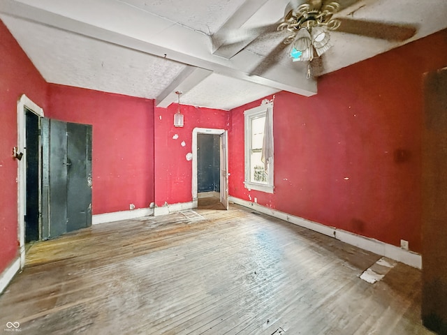 2006 N Olney St, Indianapolis, IN 46218 - spare room with beamed ceiling, ceiling fan, wood finished floors, and baseboards