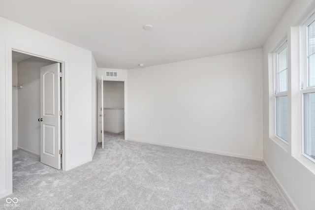 18967 Seaforth Way, Westfield, IN 46074 - unfurnished bedroom with light carpet, a spacious closet, and baseboards
