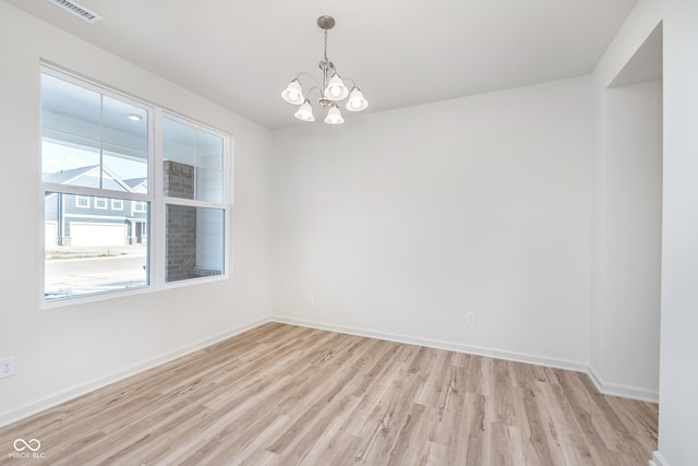 18967 Seaforth Way, Westfield, IN 46074 - spare room featuring light wood-type flooring, a chandelier, and baseboards