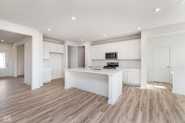 18967 Seaforth Way, Westfield, IN 46074 - kitchen featuring appliances with stainless steel finishes, a sink, tasteful backsplash, white cabinetry, and recessed lighting