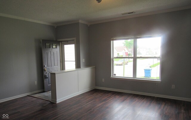 3908 Roundwood Dr, Indianapolis, IN 46235 - empty room with dark wood-style flooring, plenty of natural light, ornamental molding, a textured ceiling, and baseboards