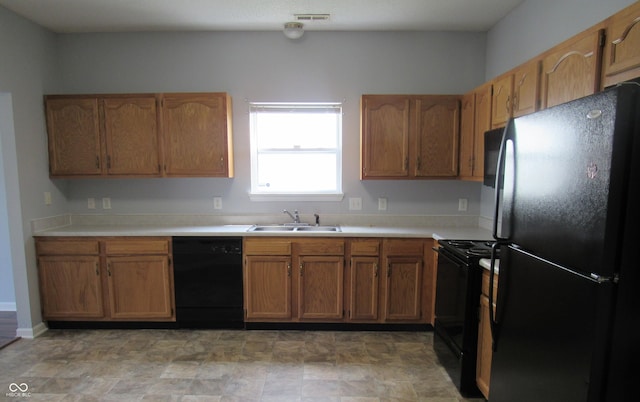 3908 Roundwood Dr, Indianapolis, IN 46235 - kitchen featuring black appliances, a sink, light countertops, and brown cabinets