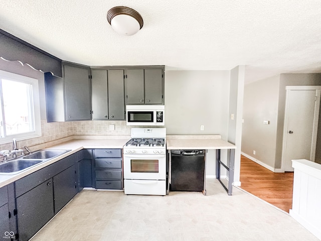 2419 Tamarack Pl, Anderson, IN 46011 - kitchen featuring white appliances, a sink, tasteful backsplash, gray cabinets, and a textured ceiling