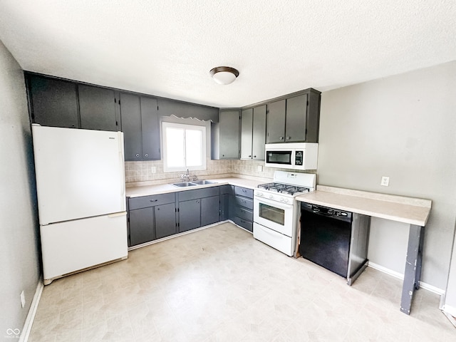 2419 Tamarack Pl, Anderson, IN 46011 - kitchen featuring white appliances, a sink, light countertops, a textured ceiling, and decorative backsplash
