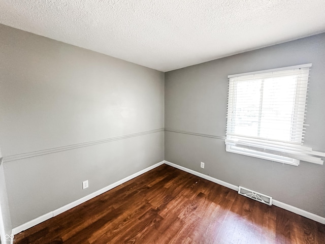 2419 Tamarack Pl, Anderson, IN 46011 - spare room featuring wood finished floors, baseboards, and a textured ceiling