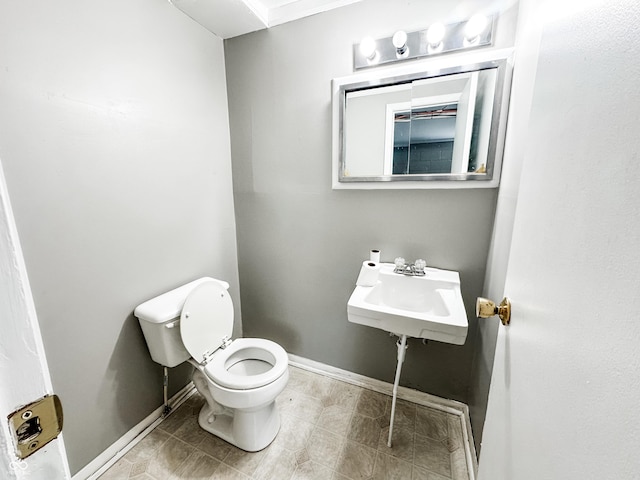 2419 Tamarack Pl, Anderson, IN 46011 - half bathroom with baseboards, toilet, and a sink