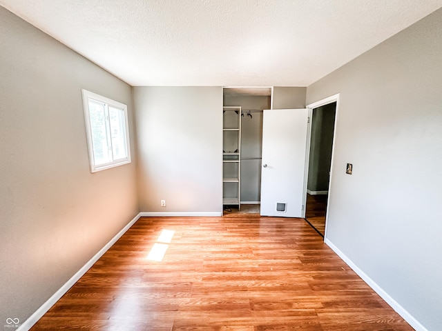 2419 Tamarack Pl, Anderson, IN 46011 - unfurnished bedroom featuring wood finished floors, baseboards, and a closet