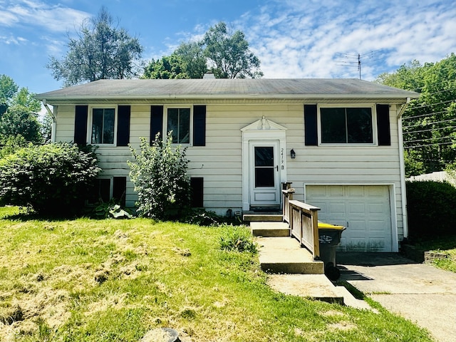 2419 Tamarack Pl, Anderson, IN 46011 - bi-level home with concrete driveway, an attached garage, and a front yard