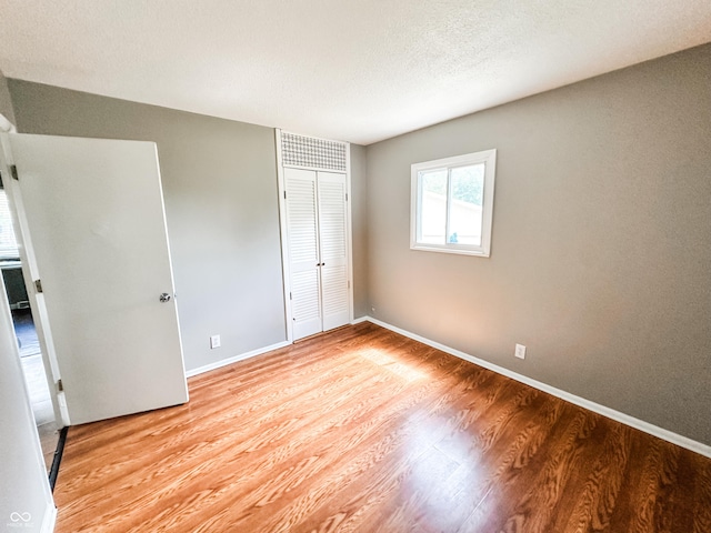 2419 Tamarack Pl, Anderson, IN 46011 - unfurnished bedroom with light wood-style floors, a closet, and baseboards