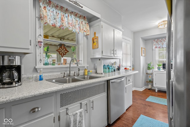 2021 Chestnut St, Columbus, IN 47201 - kitchen with appliances with stainless steel finishes, a sink, light countertops, dark wood finished floors, and white cabinetry