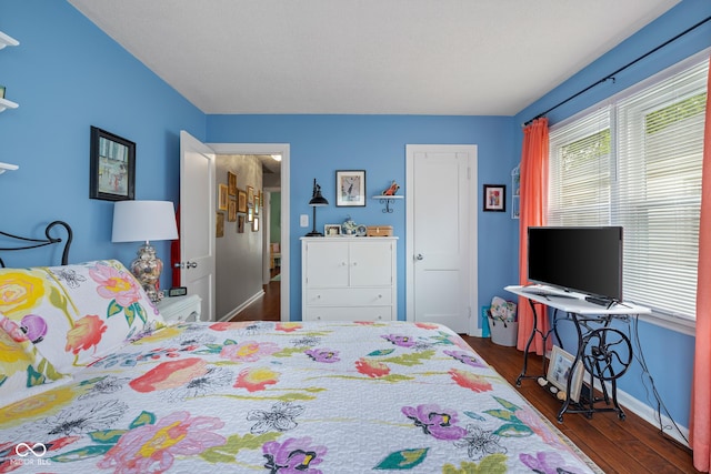 2021 Chestnut St, Columbus, IN 47201 - bedroom with multiple windows, wood finished floors, and baseboards