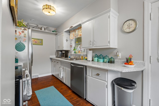 2021 Chestnut St, Columbus, IN 47201 - kitchen featuring dishwasher, a sink, light countertops, dark wood-type flooring, and white cabinets