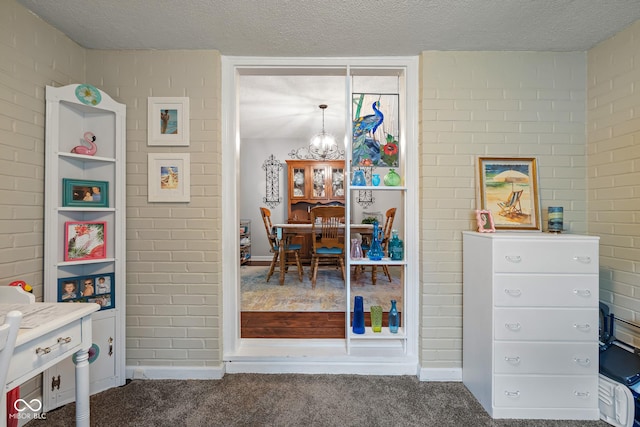 2021 Chestnut St, Columbus, IN 47201 - bedroom featuring carpet flooring, a textured ceiling, baseboards, and a chandelier