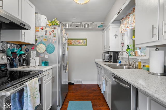 2021 Chestnut St, Columbus, IN 47201 - kitchen featuring appliances with stainless steel finishes, under cabinet range hood, a sink, baseboards, and dark wood-type flooring