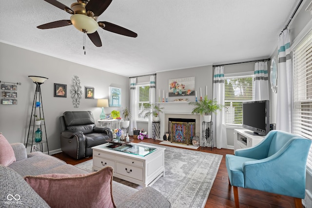 2021 Chestnut St, Columbus, IN 47201 - living room with a ceiling fan, wood finished floors, a fireplace with flush hearth, a textured ceiling, and baseboards
