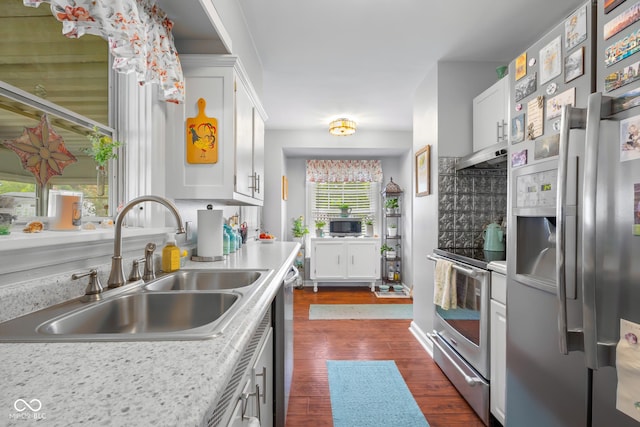 2021 Chestnut St, Columbus, IN 47201 - kitchen featuring appliances with stainless steel finishes, a sink, dark wood finished floors, light countertops, and white cabinets