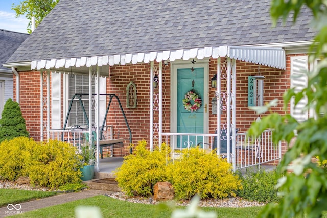 2021 Chestnut St, Columbus, IN 47201 - property entrance with a shingled roof and brick siding