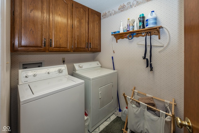 1602 Queensbridge Sq Unit 7, Indianapolis, IN 46219 - clothes washing area featuring cabinet space, washing machine and dryer, and wallpapered walls