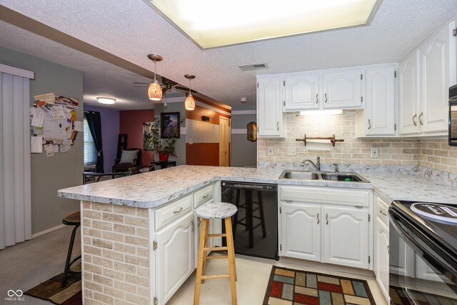 1602 Queensbridge Sq Unit 7, Indianapolis, IN 46219 - kitchen with black appliances, a sink, a peninsula, white cabinetry, and a textured ceiling