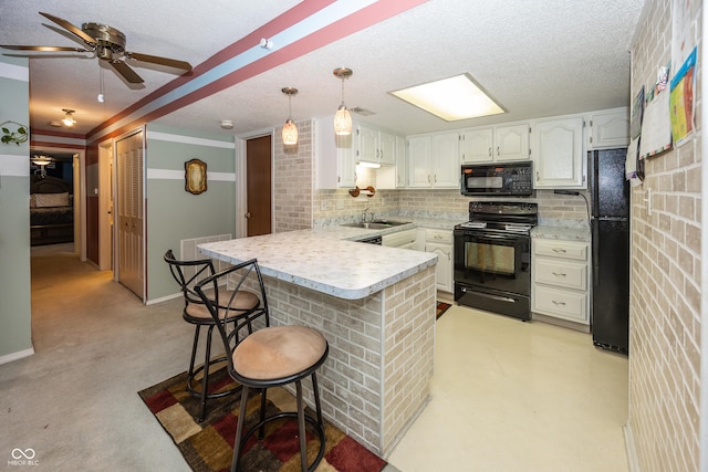 1602 Queensbridge Sq Unit 7, Indianapolis, IN 46219 - kitchen featuring black appliances, a peninsula, a sink, backsplash, and light countertops