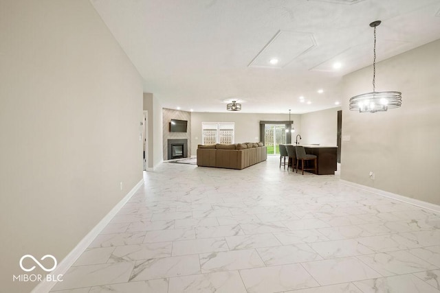 2502 Chrystal Woods Dr, Kokomo, IN 46901 - living room featuring baseboards, light marble finish floors, attic access, recessed lighting, and a fireplace