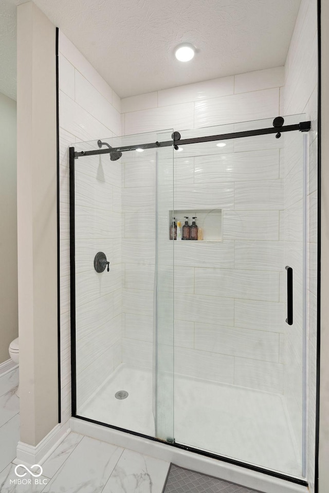2502 Chrystal Woods Dr, Kokomo, IN 46901 - bathroom with marble look tiles, toilet, a stall shower, and baseboards