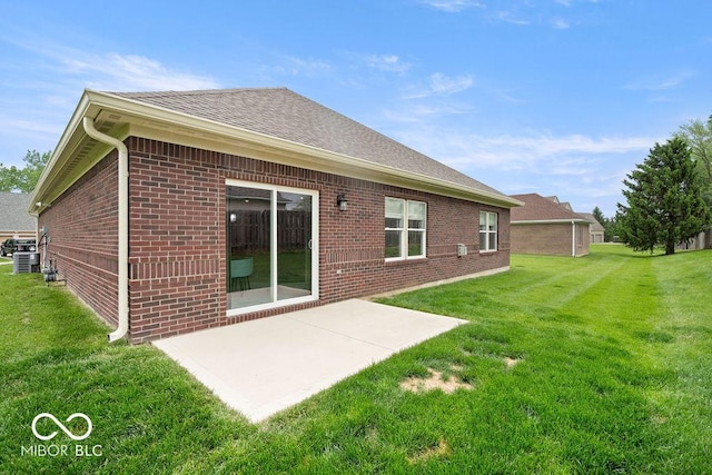 2502 Chrystal Woods Dr, Kokomo, IN 46901 - rear view of property with brick siding, a yard, a patio area, cooling unit, and a shingled roof