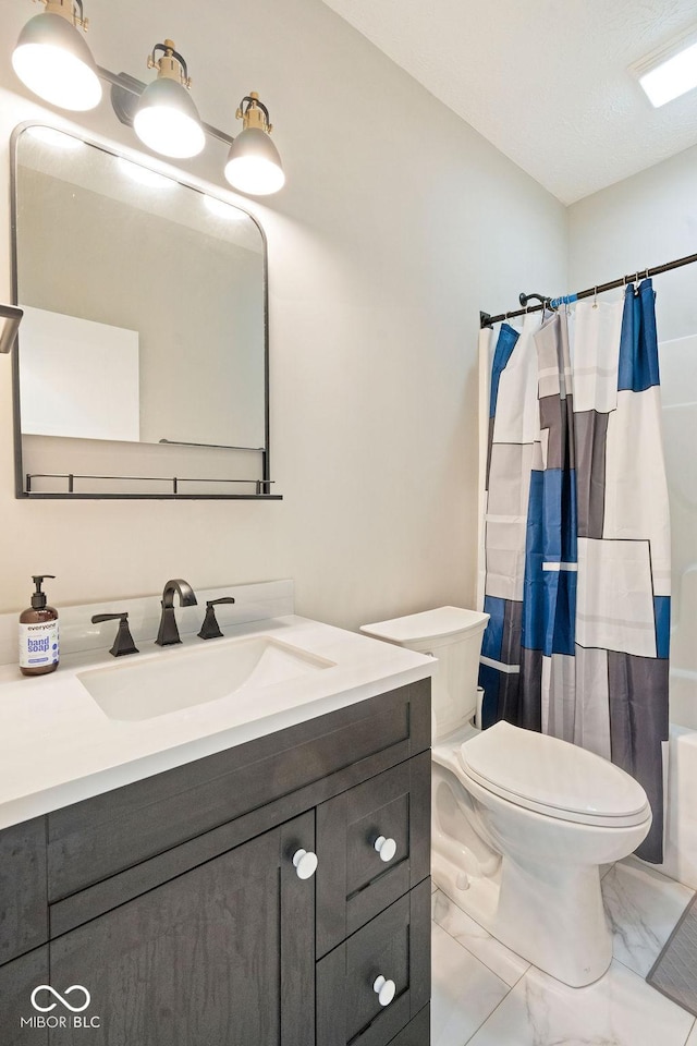 2502 Chrystal Woods Dr, Kokomo, IN 46901 - bathroom featuring marble look tile flooring, toilet, vanity, and shower / bath combo with shower curtain