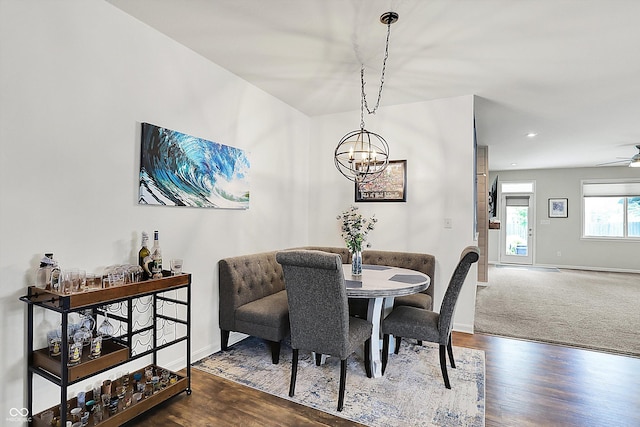 dining space featuring a chandelier, baseboards, wood finished floors, and recessed lighting