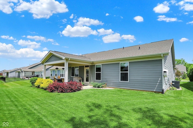 back of property featuring a lawn, central AC unit, and a patio area