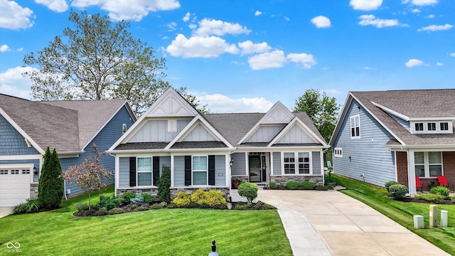 craftsman inspired home with board and batten siding, a front lawn, stone siding, and concrete driveway