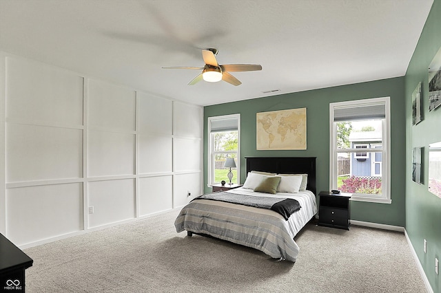 bedroom with carpet floors, multiple windows, baseboards, and a ceiling fan