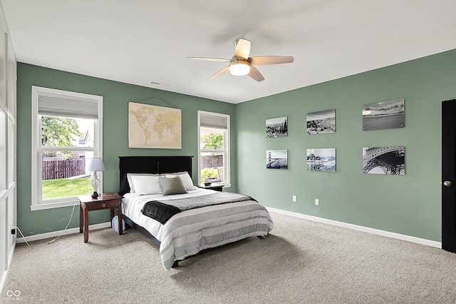 carpeted bedroom with baseboards and a ceiling fan