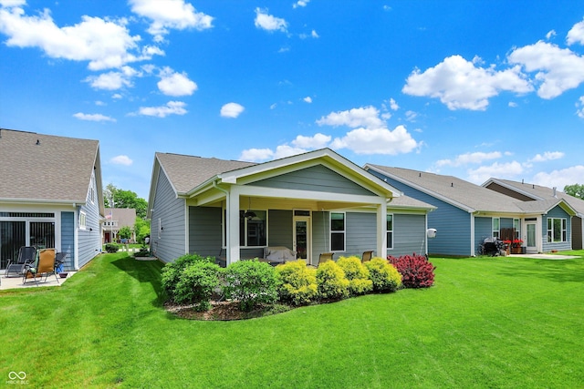 back of house featuring a yard and a patio area