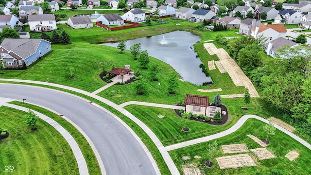 aerial view of property's location featuring a nearby body of water and nearby suburban area