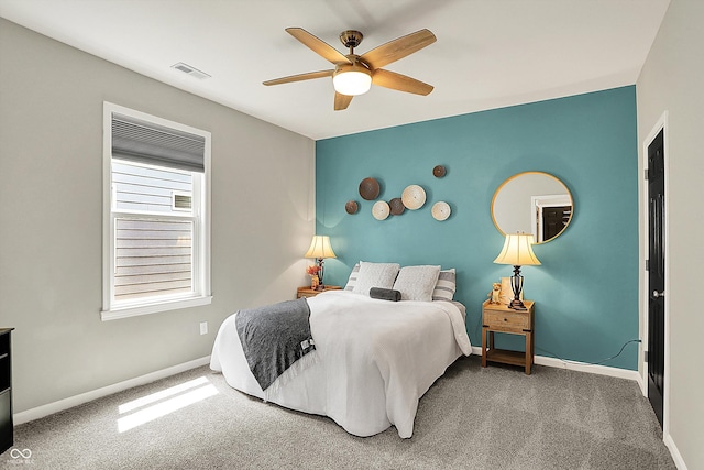 carpeted bedroom featuring baseboards and ceiling fan
