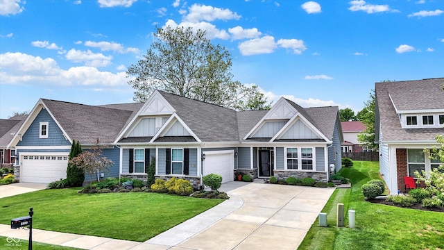craftsman-style house featuring board and batten siding, a front yard, an attached garage, stone siding, and driveway
