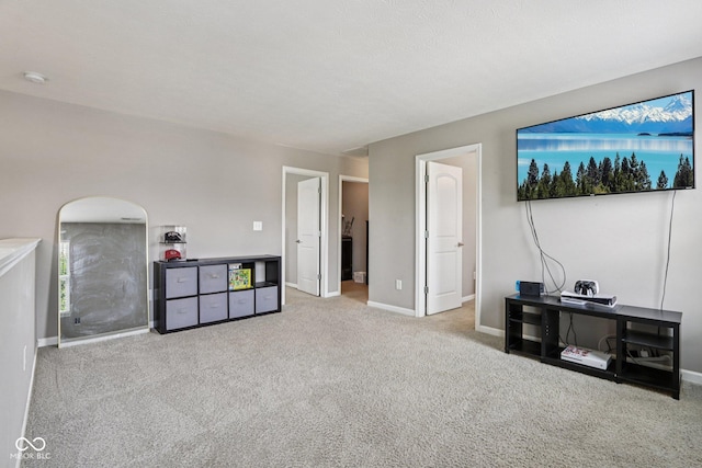 220 Sawdust Trl, Greenfield, IN 46140 - carpeted living area featuring baseboards and arched walkways