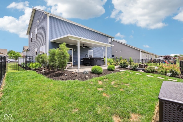 220 Sawdust Trl, Greenfield, IN 46140 - back of property featuring a hot tub, ceiling fan, a patio, and a fenced backyard