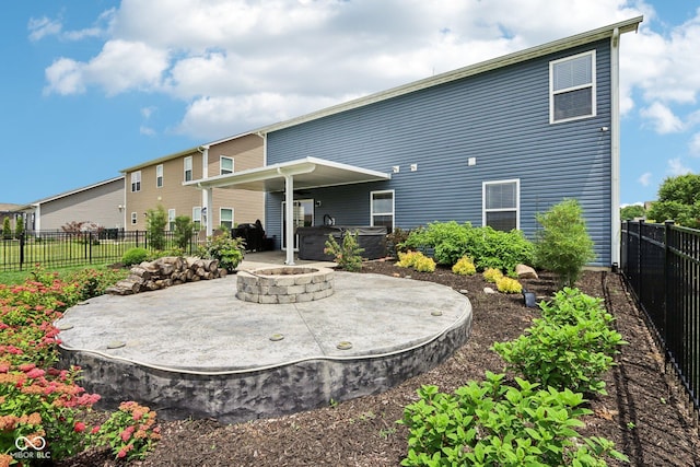 220 Sawdust Trl, Greenfield, IN 46140 - rear view of property featuring a hot tub, a patio, a fenced backyard, and an outdoor fire pit