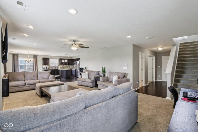 220 Sawdust Trl, Greenfield, IN 46140 - living area with carpet flooring, ceiling fan, a chandelier, stairway, and recessed lighting