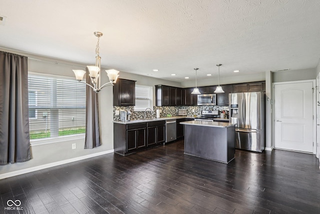 220 Sawdust Trl, Greenfield, IN 46140 - kitchen featuring stainless steel appliances, light countertops, a chandelier, dark brown cabinets, and tasteful backsplash
