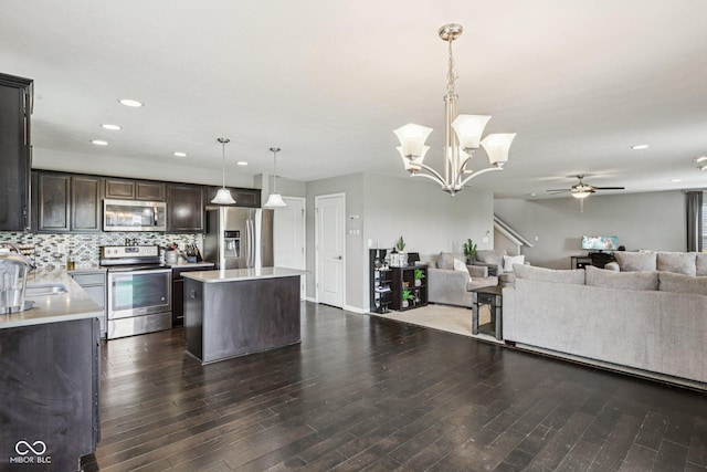 220 Sawdust Trl, Greenfield, IN 46140 - kitchen with appliances with stainless steel finishes, open floor plan, a ceiling fan, dark brown cabinets, and light countertops