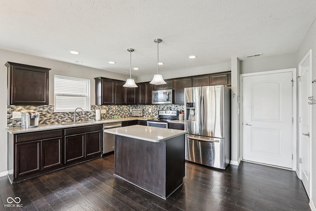 220 Sawdust Trl, Greenfield, IN 46140 - kitchen featuring stainless steel appliances, dark brown cabinetry, decorative backsplash, dark wood finished floors, and a textured ceiling