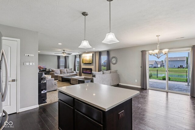 220 Sawdust Trl, Greenfield, IN 46140 - kitchen with dark wood-type flooring, light countertops, open floor plan, a kitchen island, and a chandelier