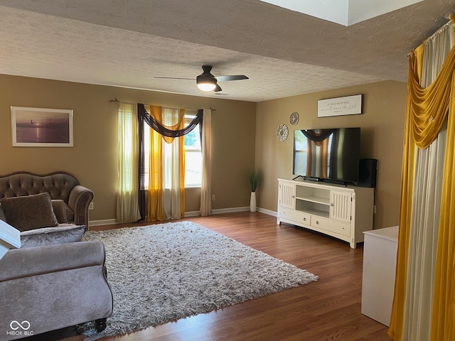 5241 Waterton Lakes Dr, Indianapolis, IN 46237 - living area featuring a ceiling fan, a textured ceiling, dark wood finished floors, and baseboards