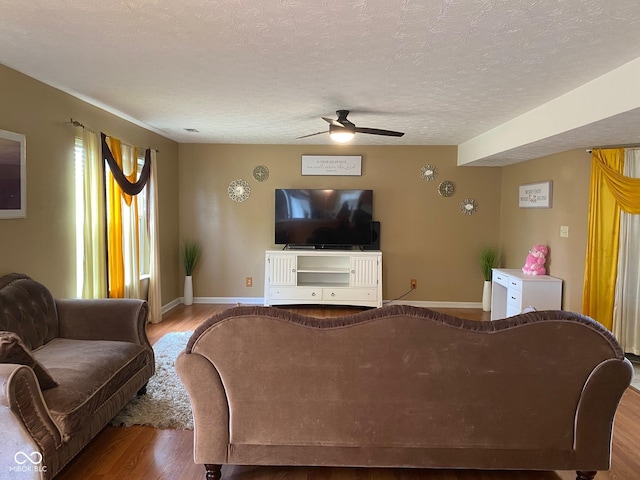5241 Waterton Lakes Dr, Indianapolis, IN 46237 - living room featuring wood finished floors, a ceiling fan, baseboards, and a textured ceiling