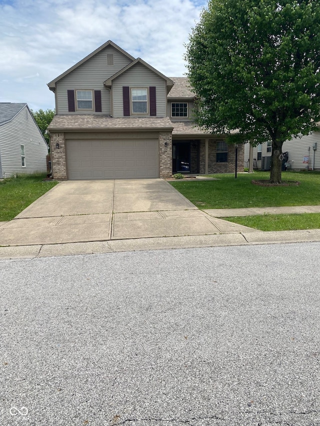 5241 Waterton Lakes Dr, Indianapolis, IN 46237 - view of front facade featuring brick siding, a garage, concrete driveway, and a front lawn