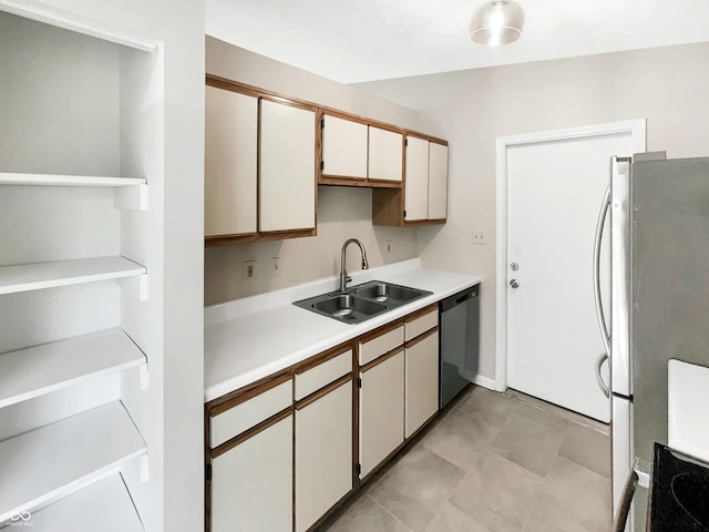 kitchen featuring dishwasher, a sink, light countertops, open shelves, and freestanding refrigerator